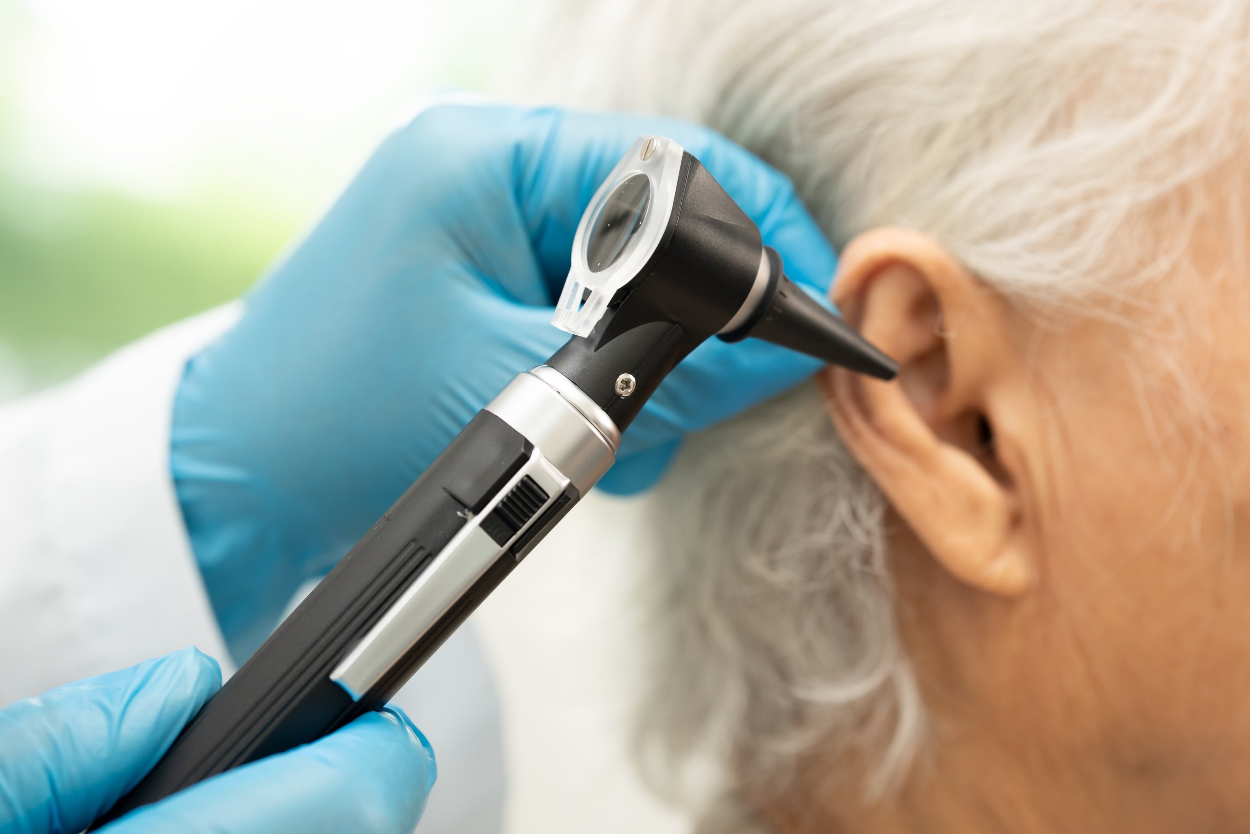 Professional ear examination in home setting